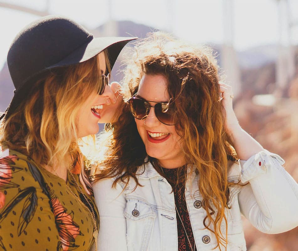 Deux amies souriantes portant des lunettes de soleil